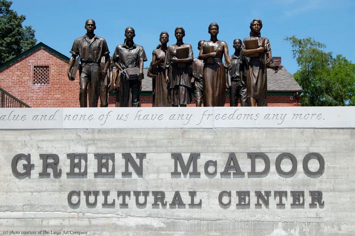 Sign of the Green McAdoo Cultural Center with the Clinton 12 statue above it